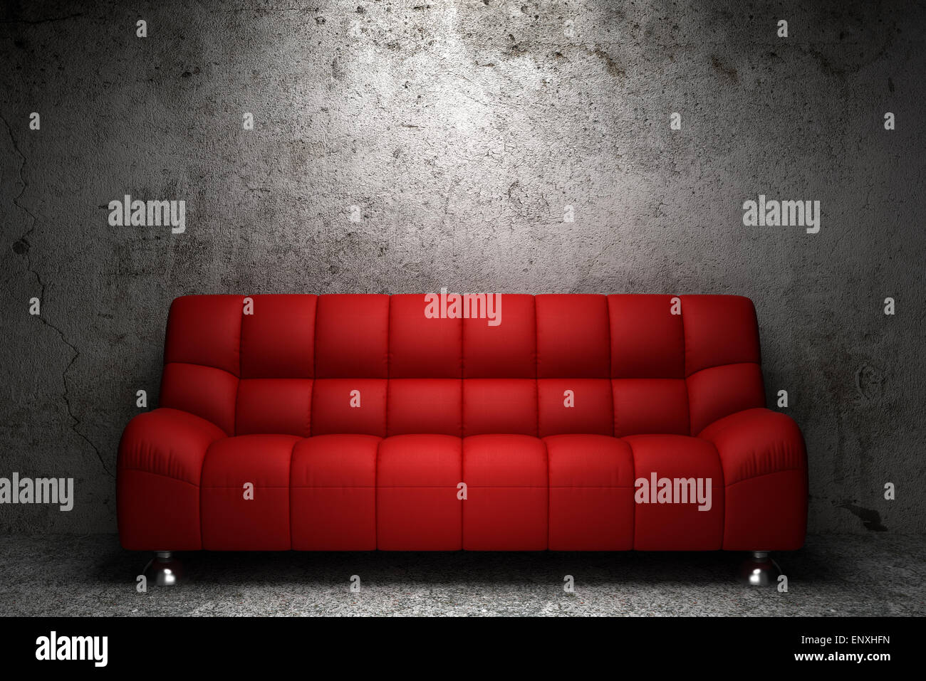 red leather sofa in front of grunge concrete wall Stock Photo