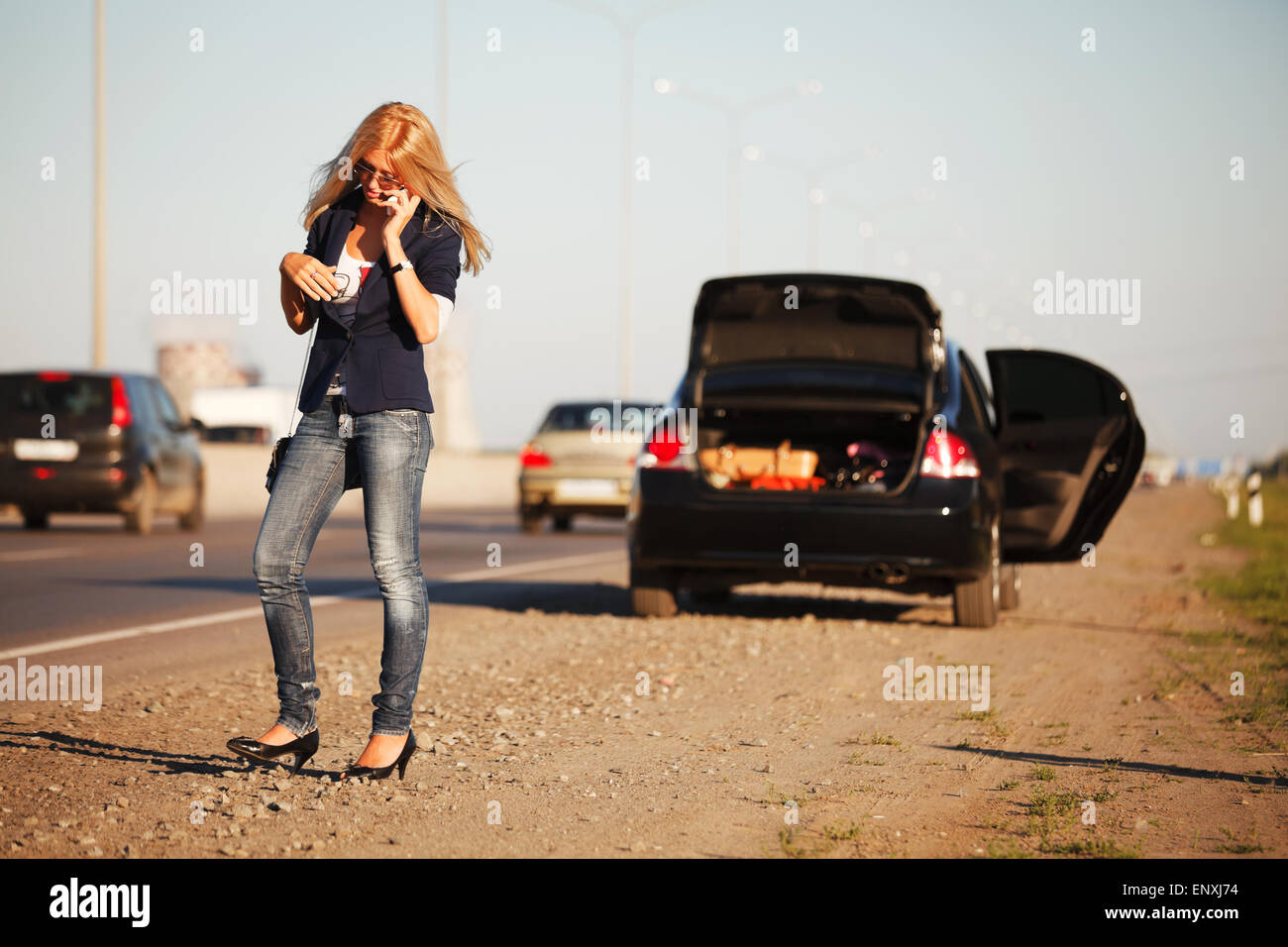 Young woman with a broken car calling for help Stock Photo - Alamy