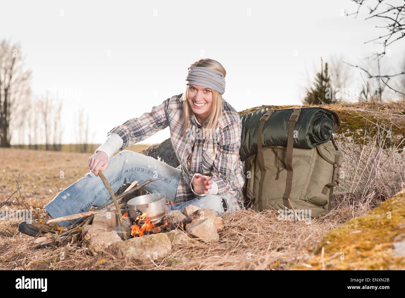 Campfire hiking woman with backpack cook country Stock Photo Alamy