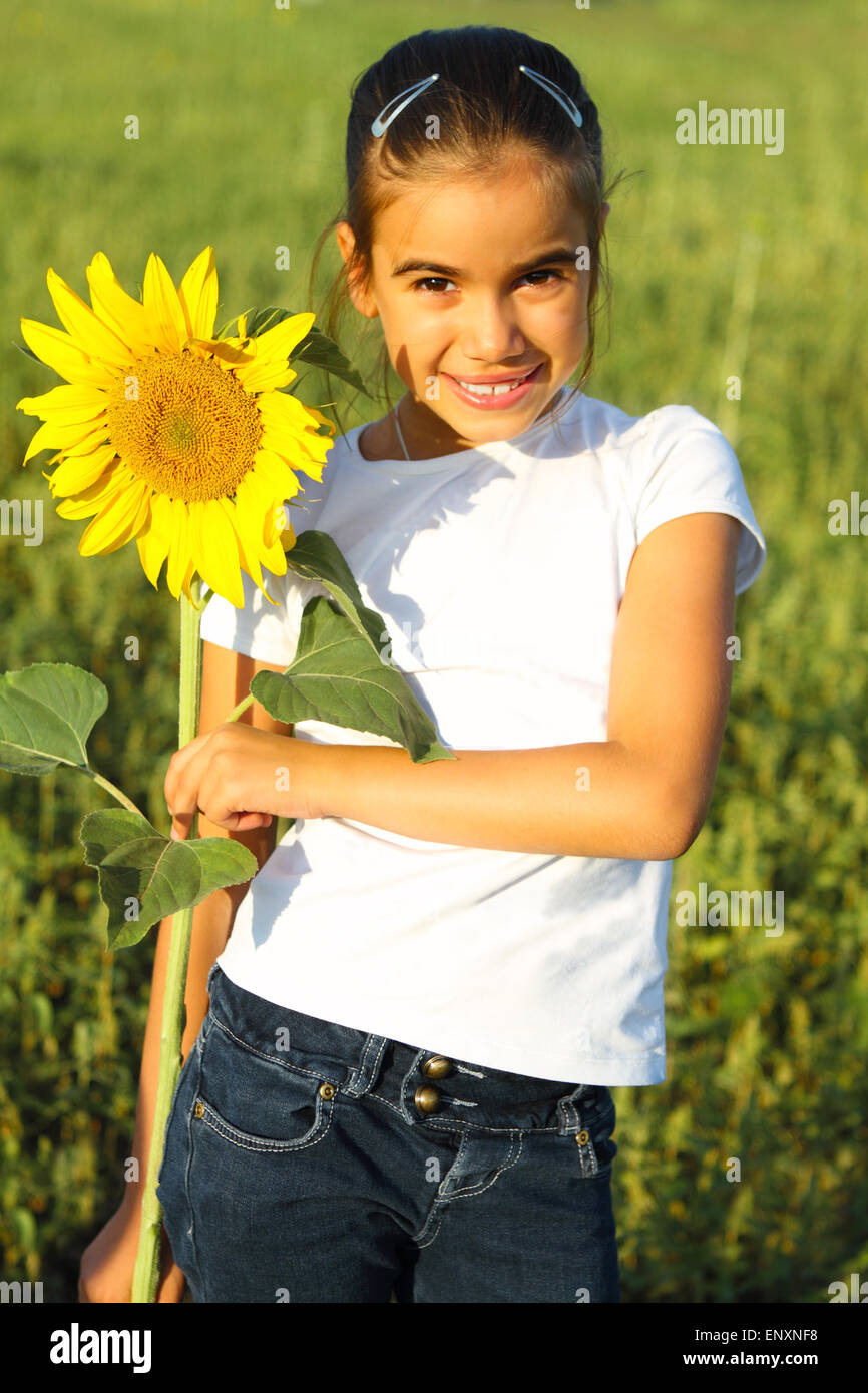 Portrait of a cute little girl with sunflower Stock Photo - Alamy