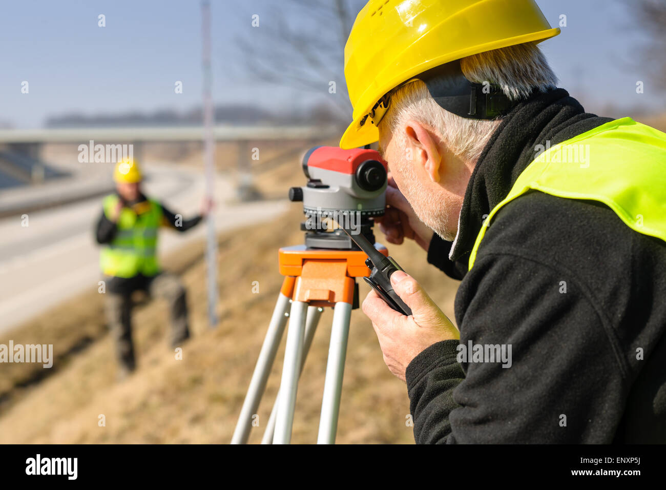 Geodesist measure land with tacheometer highway Stock Photo - Alamy