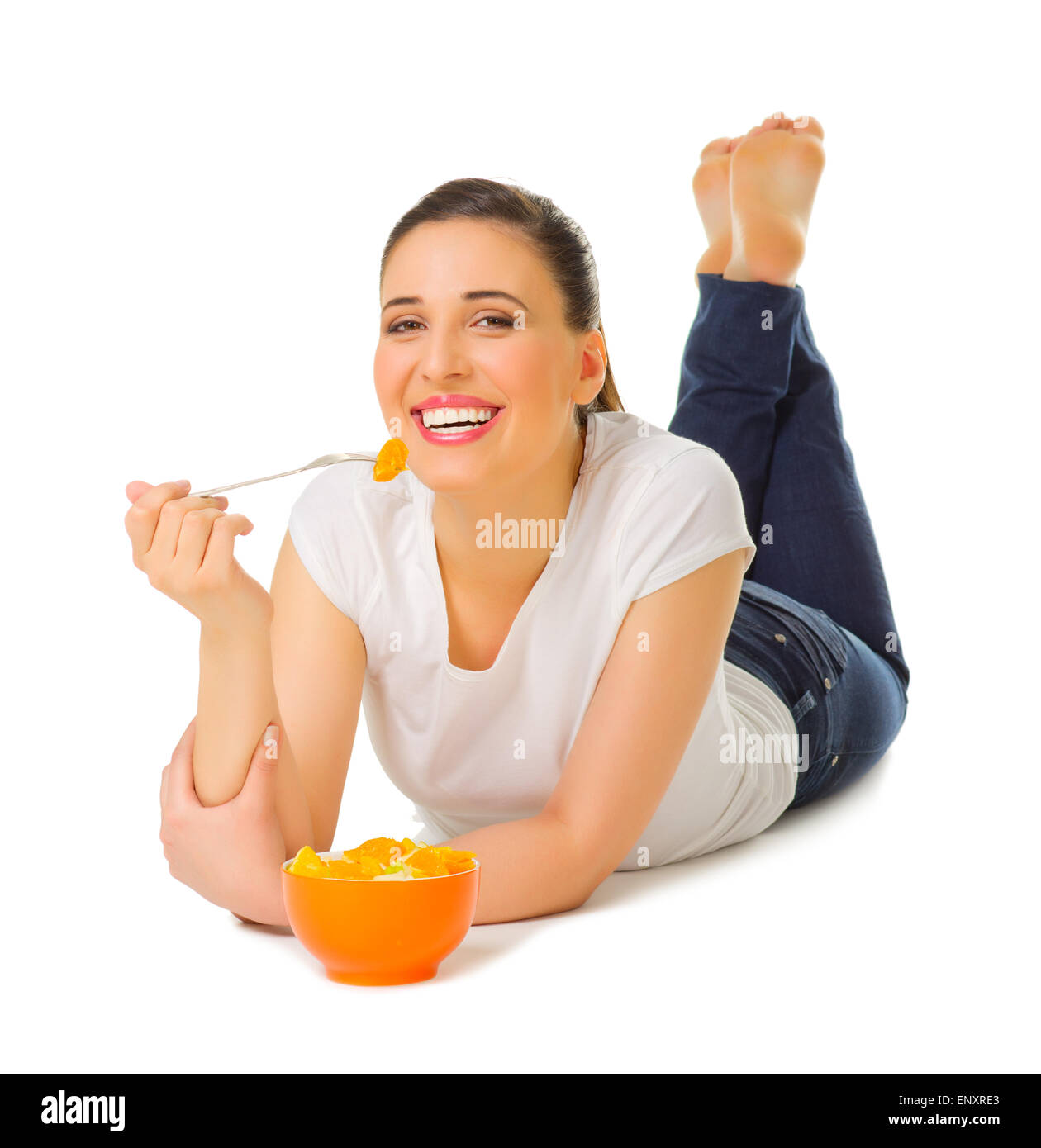 Young girl laying on the floor with fruit salad isolated Stock Photo