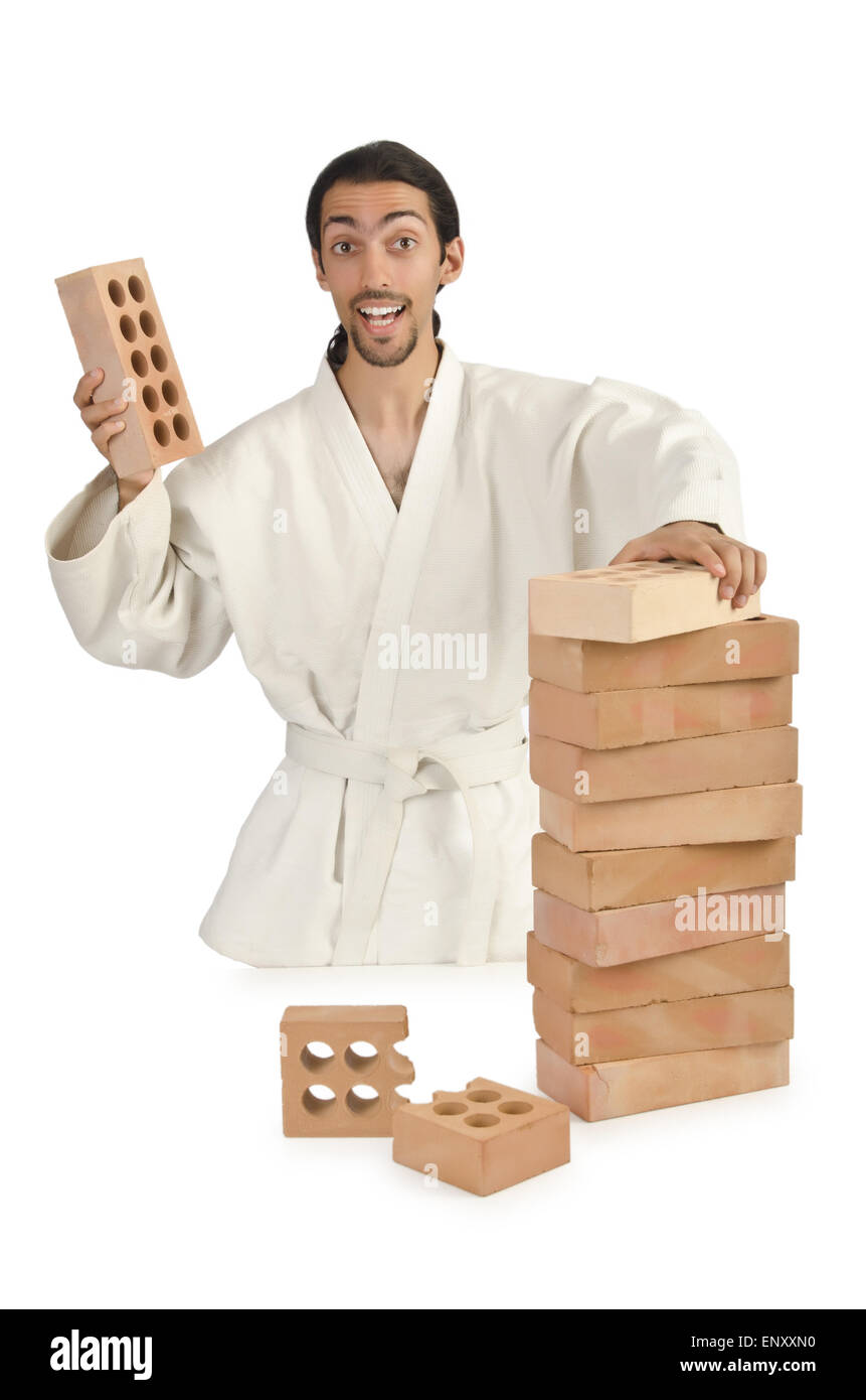 Karate man breaking bricks on white Stock Photo