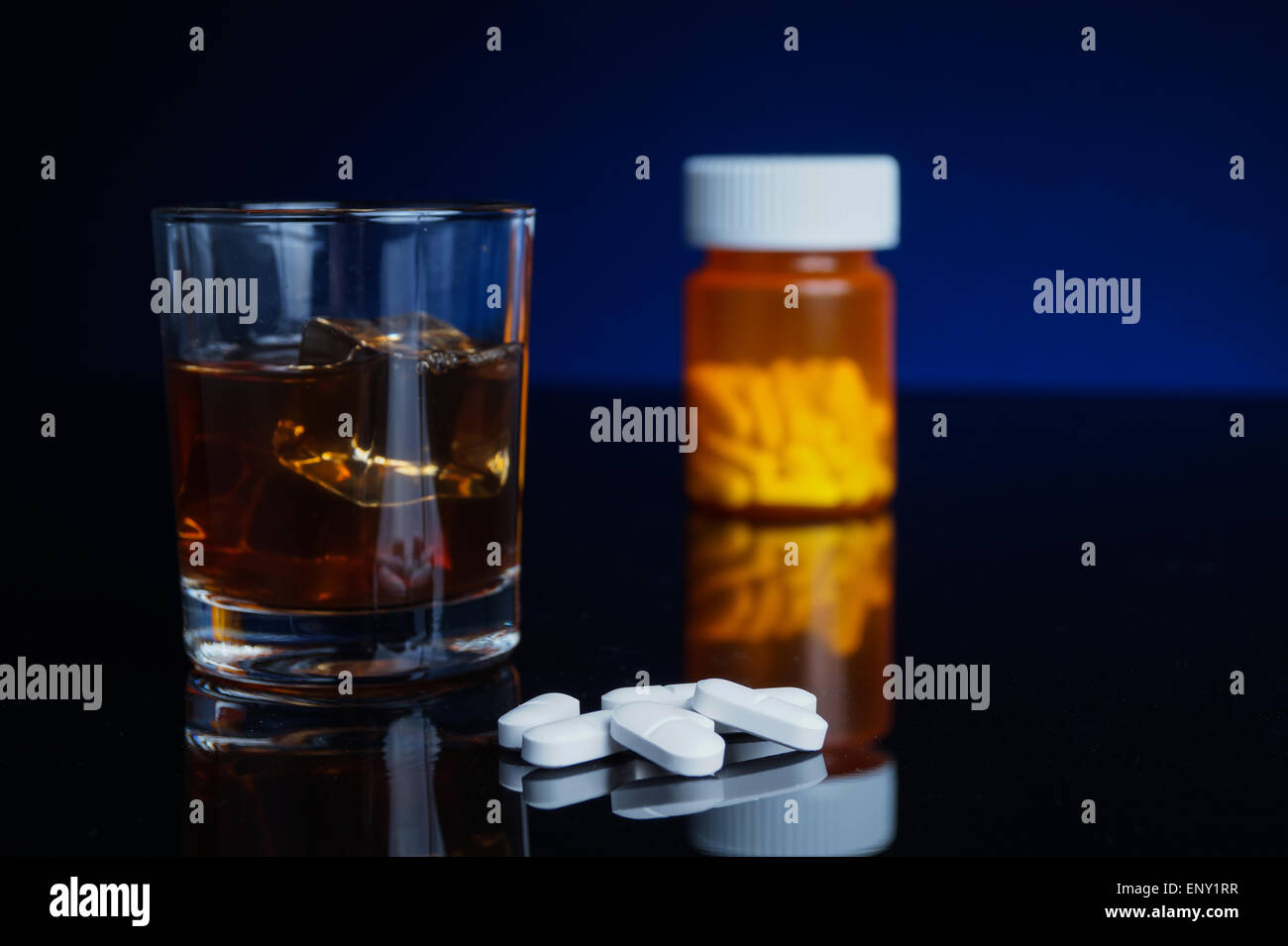 Alcohol and medicine. Glass, pills and bottle Stock Photo