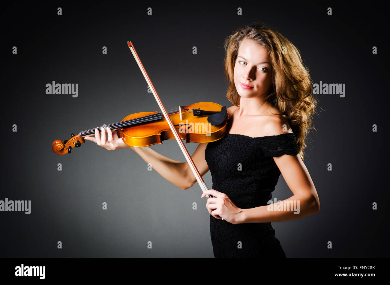 Woman with violin in dark room Stock Photo - Alamy