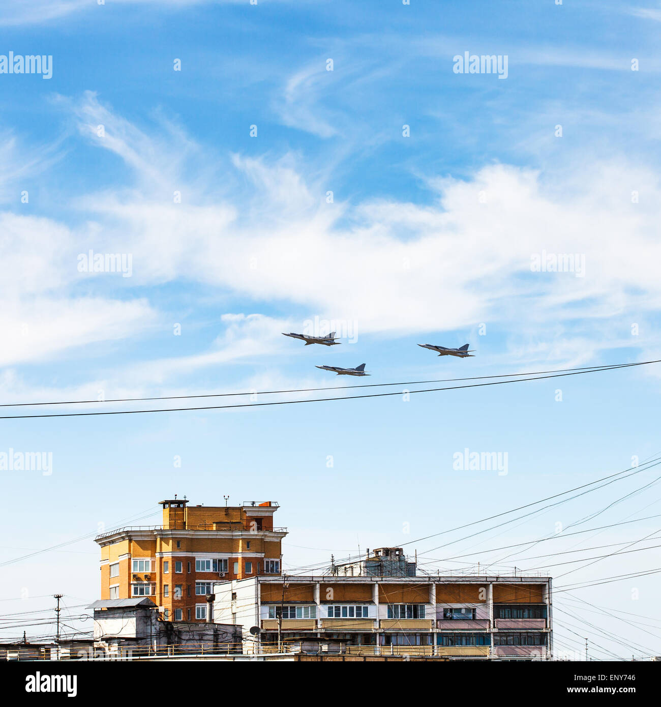 military aircrafts flight in blue sky over urban house Stock Photo - Alamy