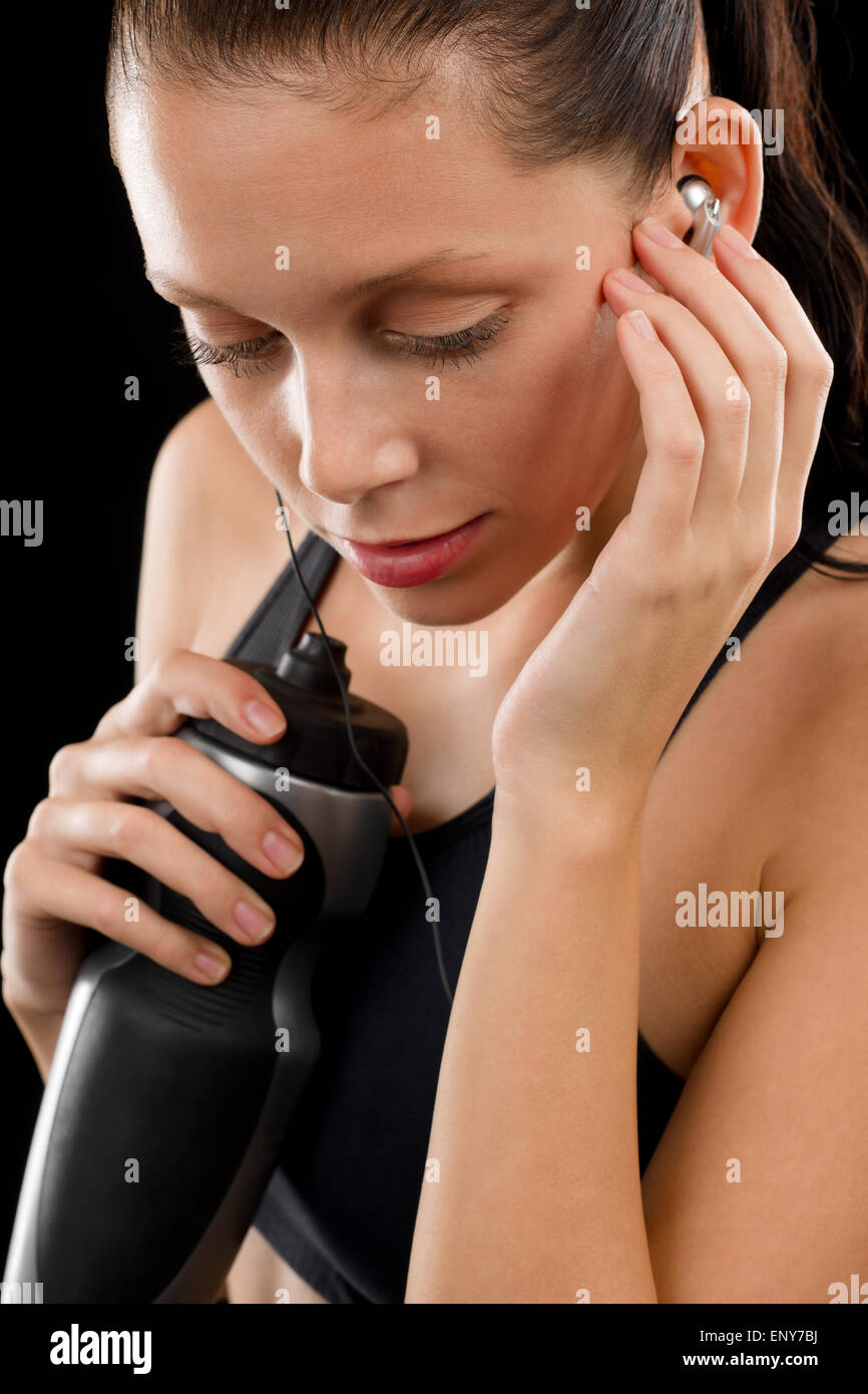 Active woman portrait with water bottle headphones Stock Photo