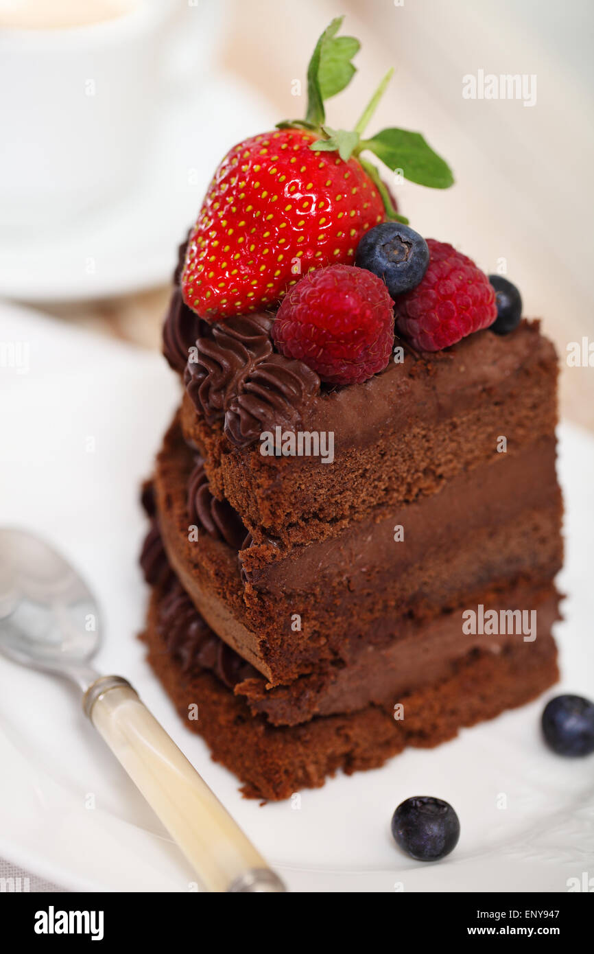 Piece of chocolate cake with icing and fresh berry Stock Photo - Alamy