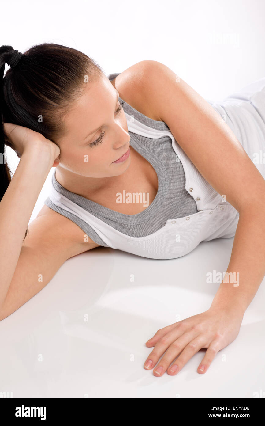 Young woman thinking and relaxing after exercises Stock Photo