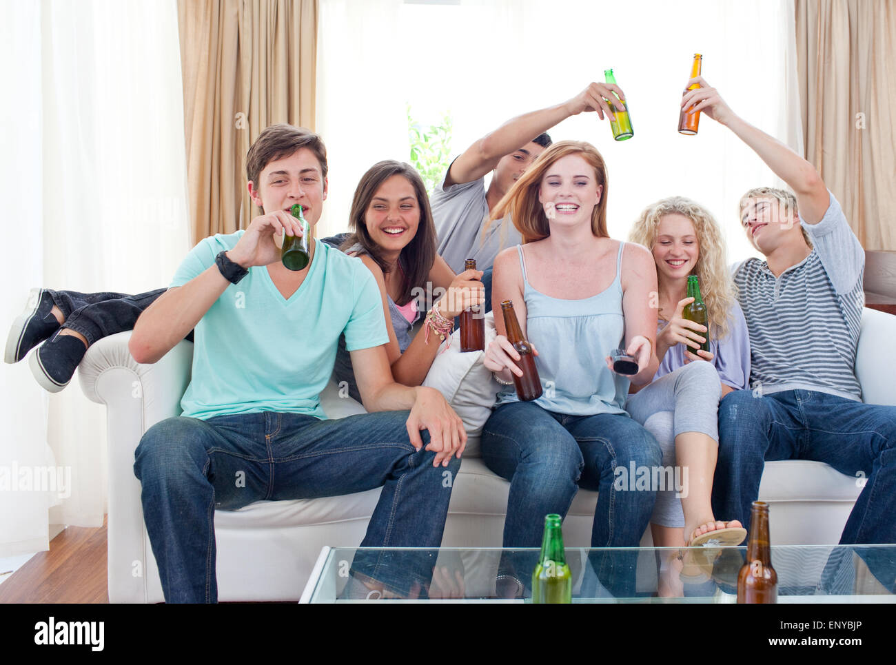 Friends drinking beer at home Stock Photo - Alamy