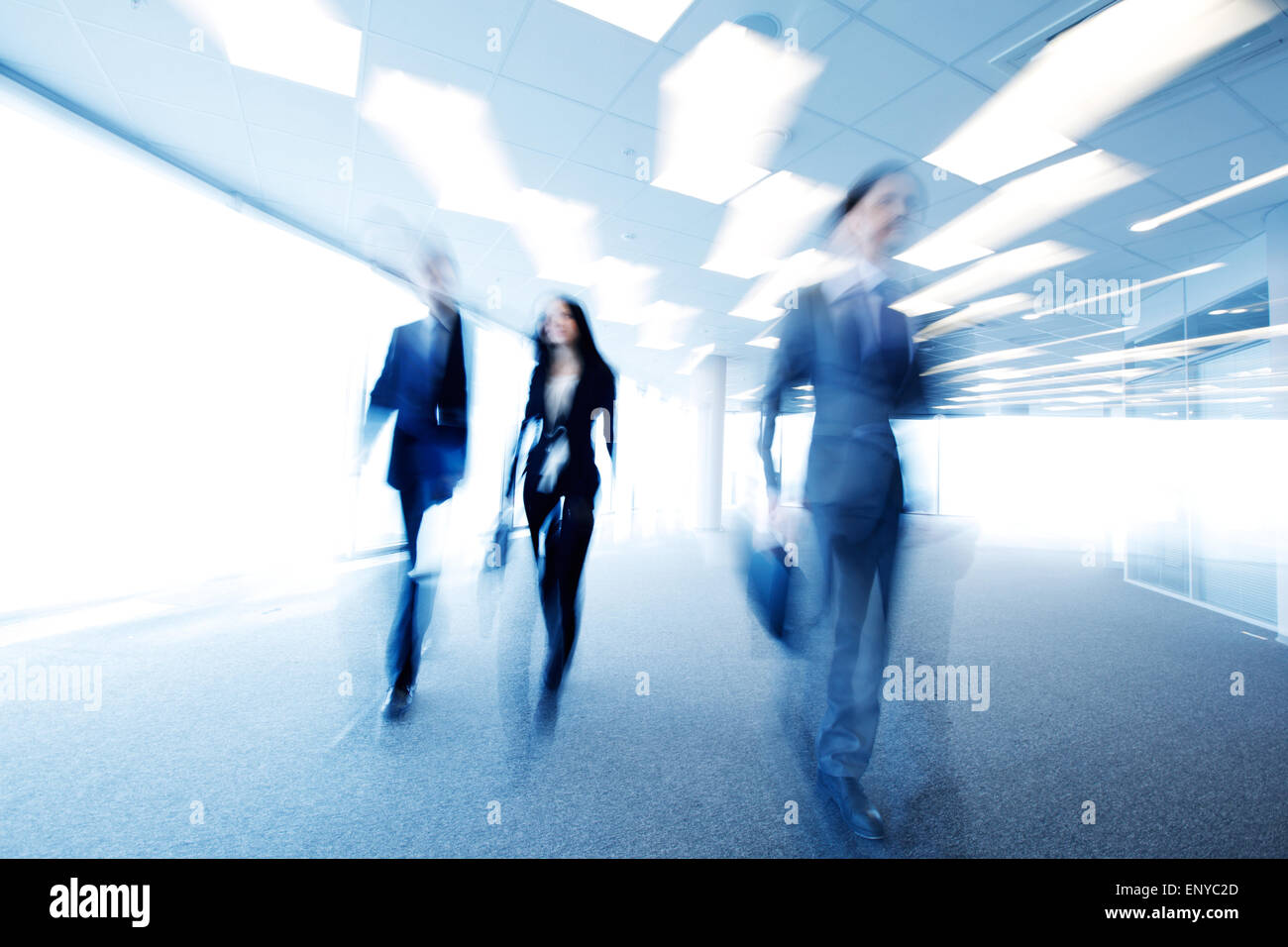 business people walking through office blurred Stock Photo - Alamy