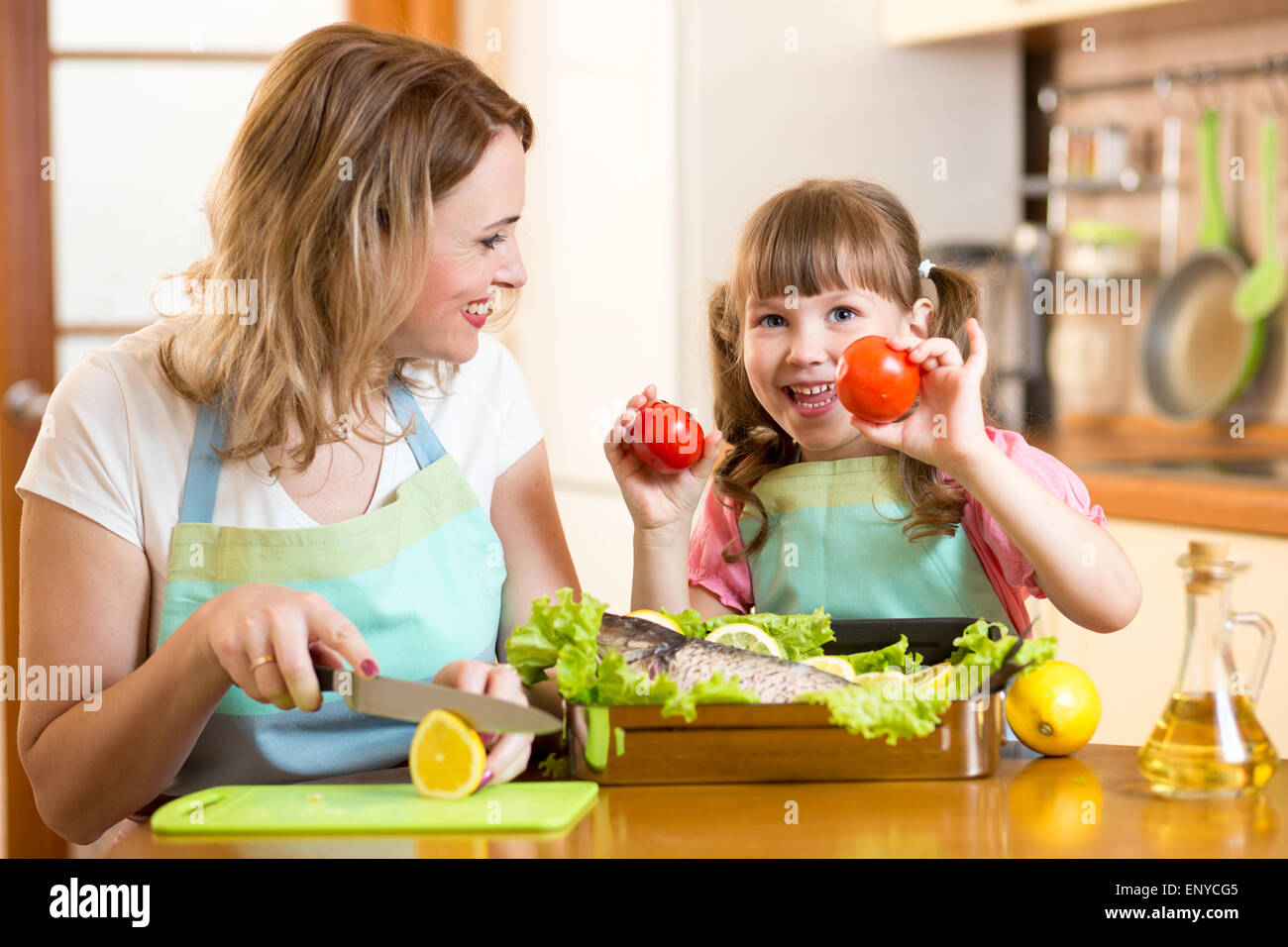 mother and kid cooking and having fun in kitchen Stock Photo