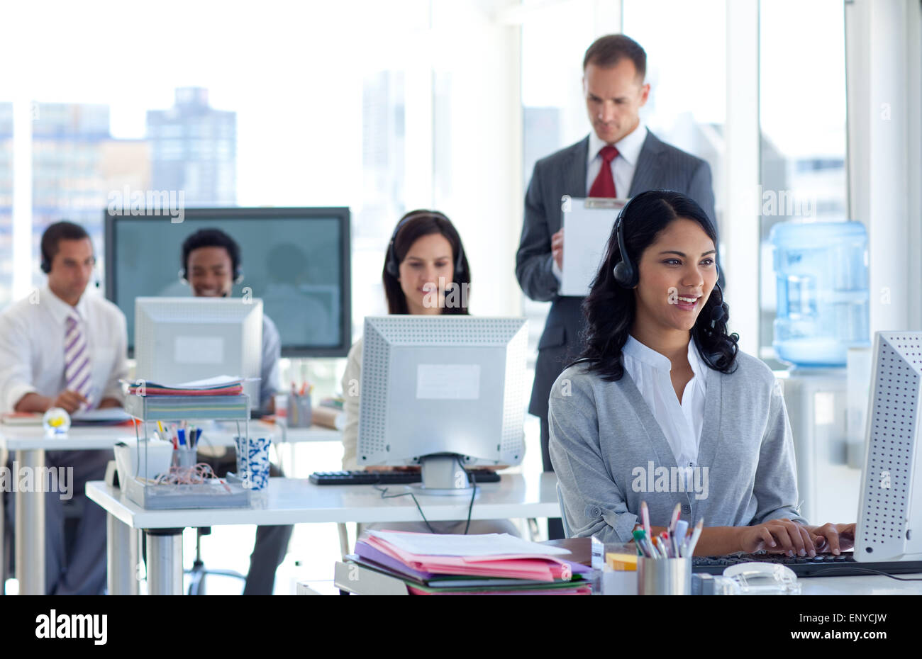 Supervisor taking notes in a call center Stock Photo - Alamy