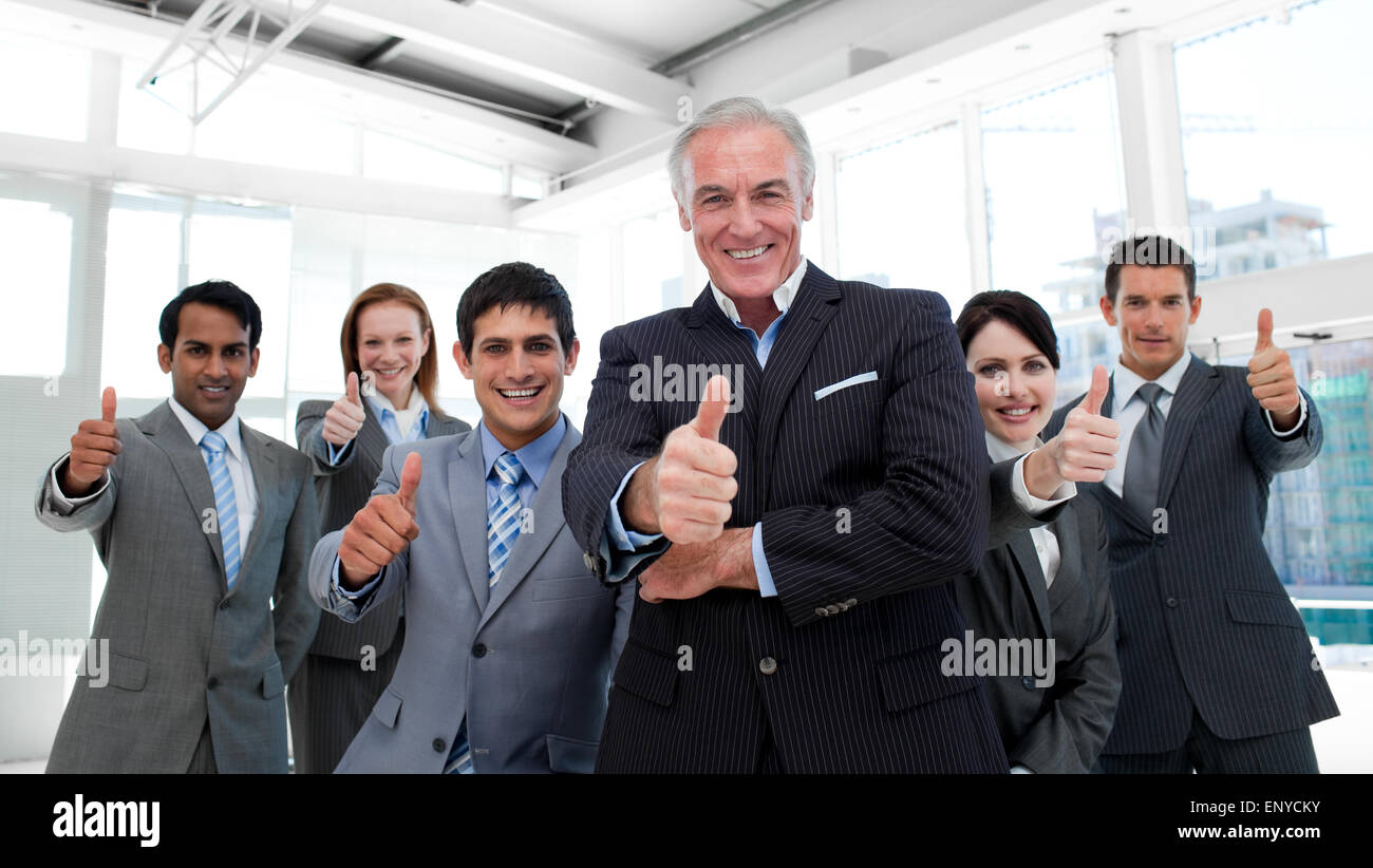 Happy multi-ethnic business team with thumbs up Stock Photo - Alamy