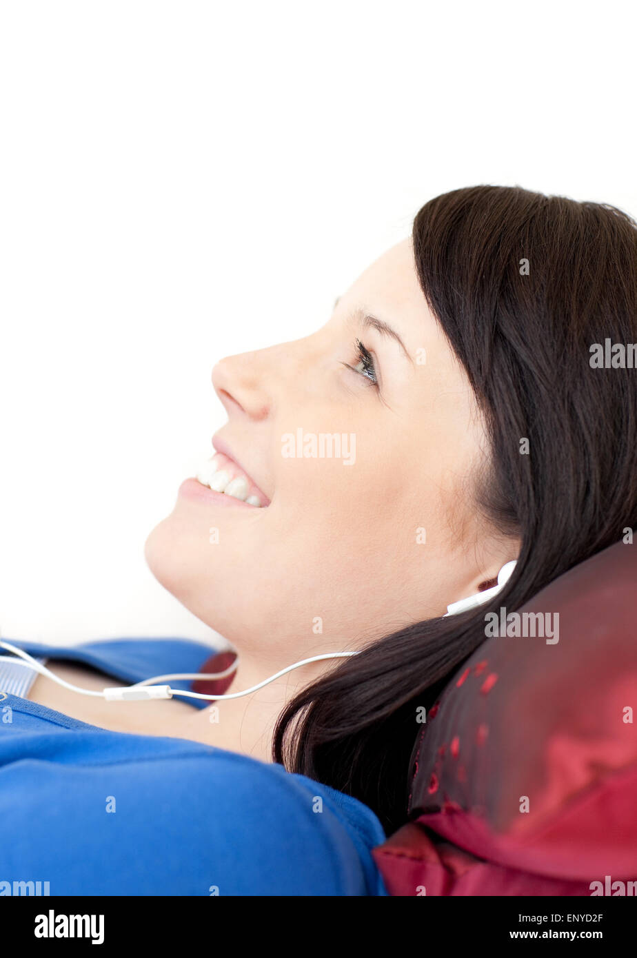 Cheerful teen girl listening music lying on a sofa Stock Photo - Alamy