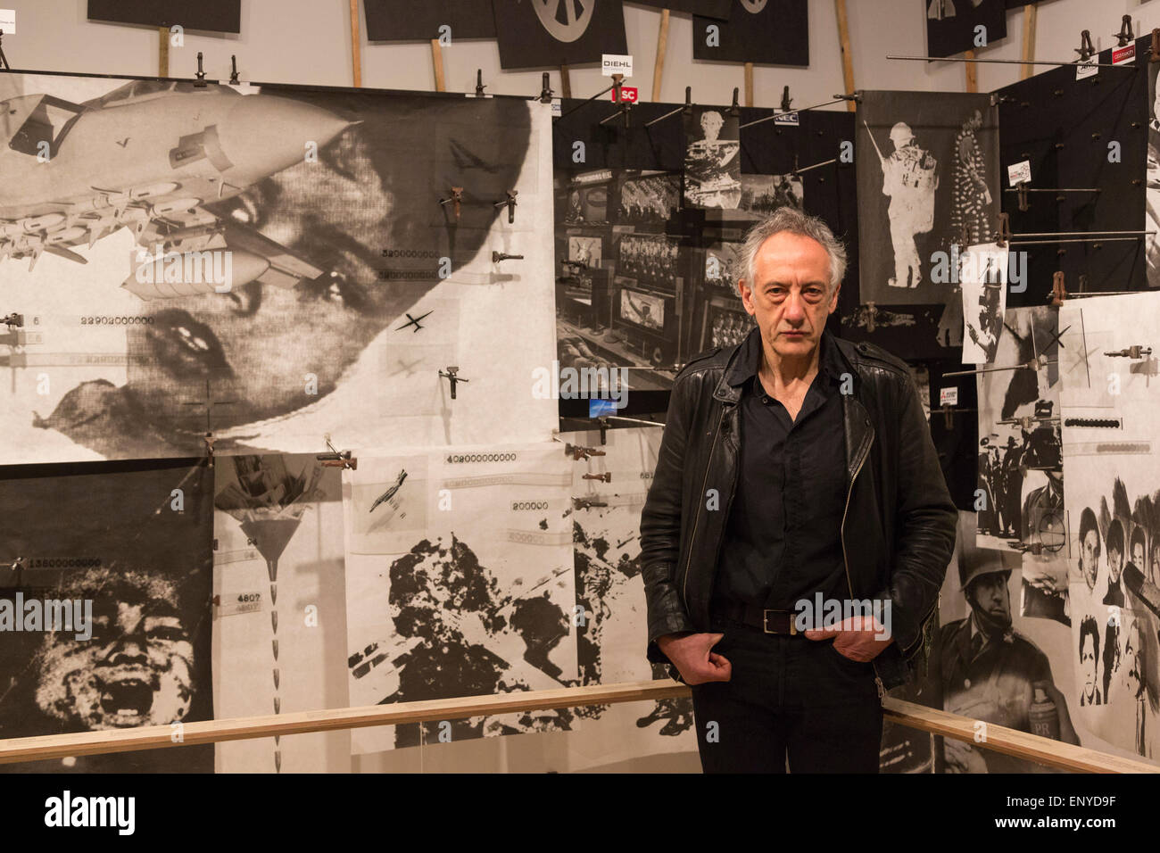 London, UK. 12 May 2015. Pictured: artist Peter Kennard (born 1949). Press preview of the exhibition 'Peter Kennard: Unofficial War Artist' at the Imperial War Museum in London, UK. The exhibition opens on 14 May 2015 and runs until 30 May 2016. This free exhibition at IWM London will be the first major retrospective of Kennard's work charting a 50 year career featuring over 200 artworks and related items, including a new art installation ‘Boardroom’ created especially for the exhibition. Political artist Peter Kennard has inpired artists from Mark Wallinger to Banksy. Stock Photo