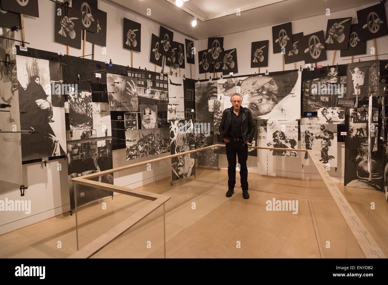 London, UK. 12 May 2015. Pictured: artist Peter Kennard (born 1949). Press preview of the exhibition 'Peter Kennard: Unofficial War Artist' at the Imperial War Museum in London, UK. The exhibition opens on 14 May 2015 and runs until 30 May 2016. This free exhibition at IWM London will be the first major retrospective of Kennard's work charting a 50 year career featuring over 200 artworks and related items, including a new art installation ‘Boardroom’ created especially for the exhibition. Political artist Peter Kennard has inpired artists from Mark Wallinger to Banksy. Stock Photo