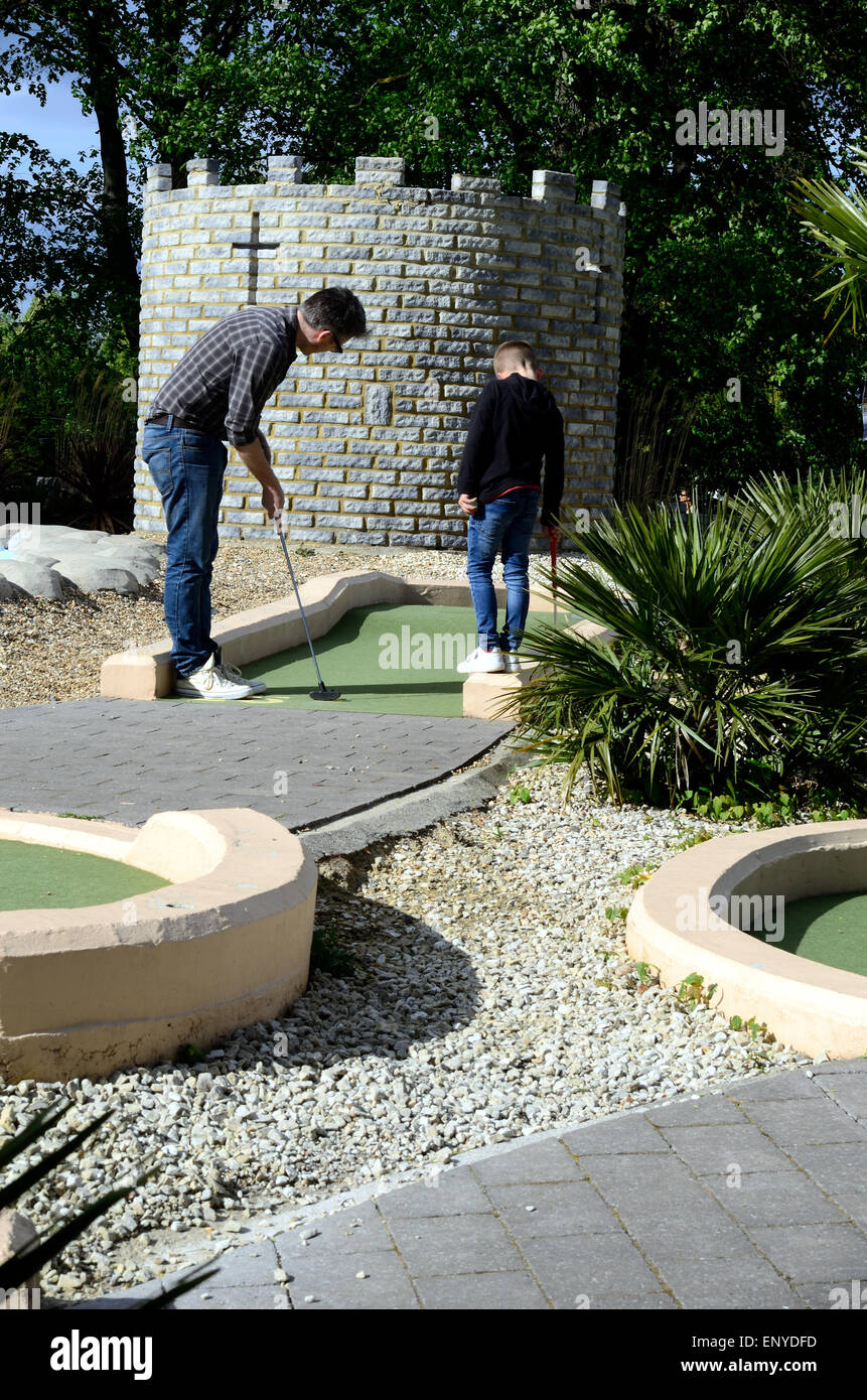 A father and son playing crazy golf in Windsor. Stock Photo