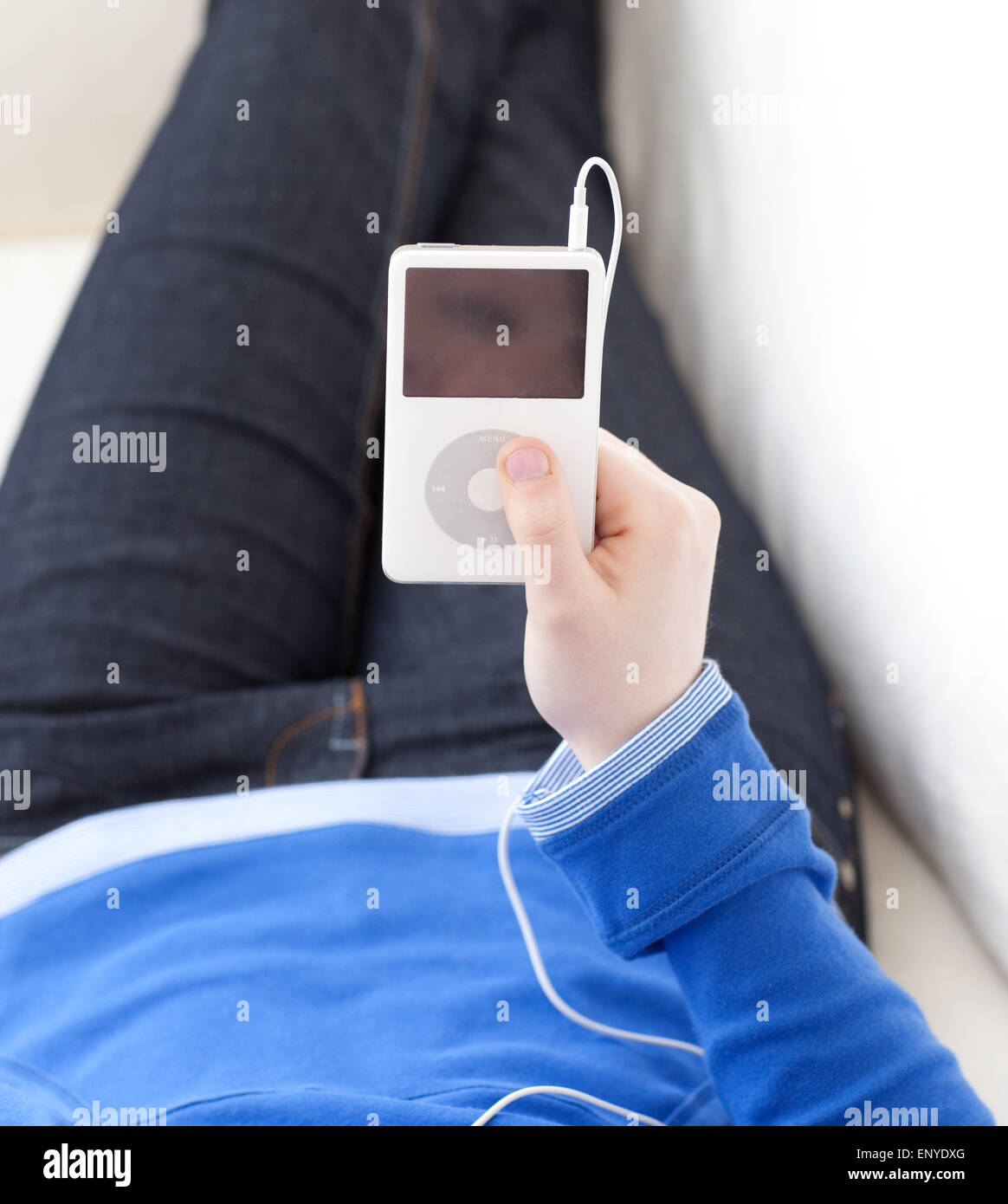 Close-up of a teen girl listening music lying on a sofa Stock Photo - Alamy