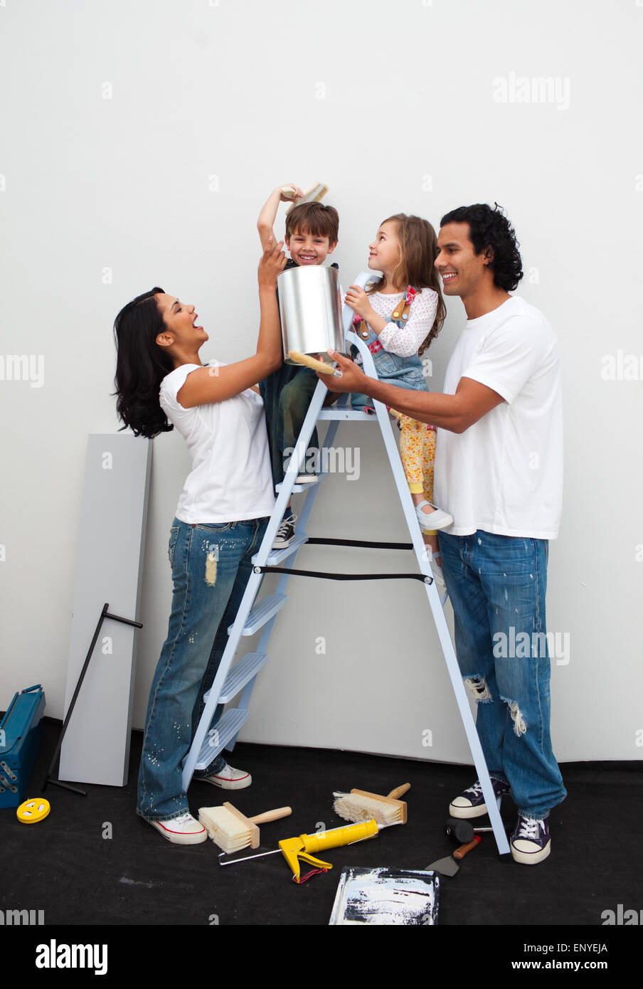 Happy family painting a room Stock Photo - Alamy