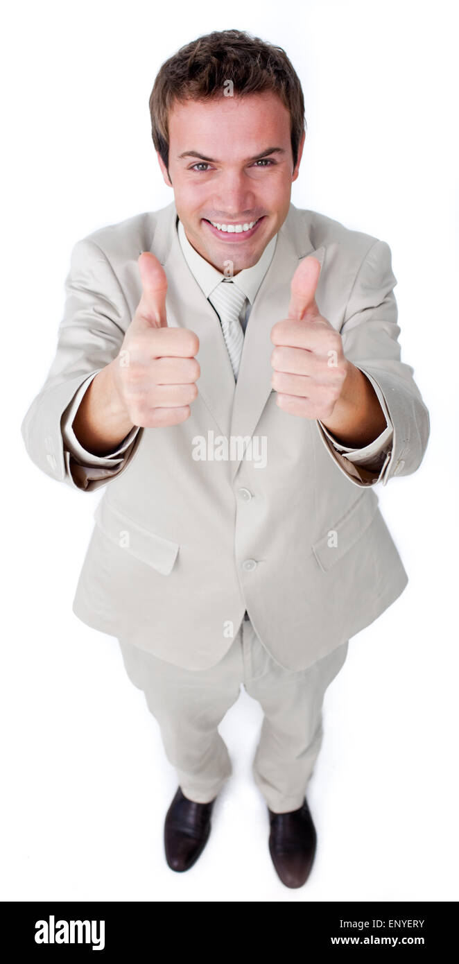 Victorious businessman with thumbs up smiling at the camera Stock Photo ...