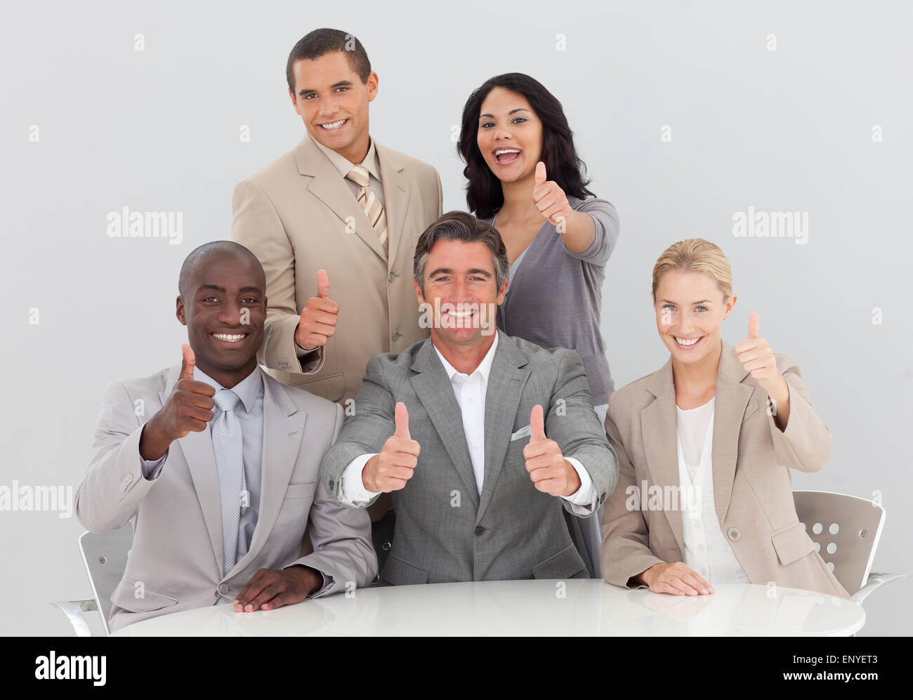 Happy business team celebrating a success with thumbs up Stock Photo ...