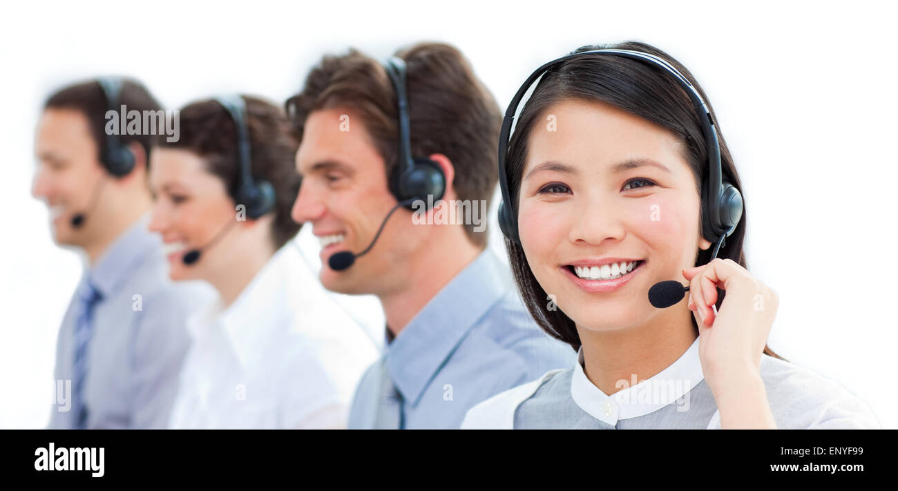 Portrait of smiling customer service agents working in a call center ...