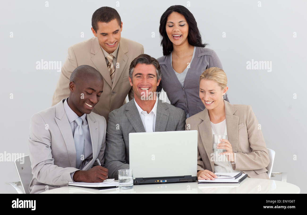 Smiling multi-ethnic business team working in office together Stock ...