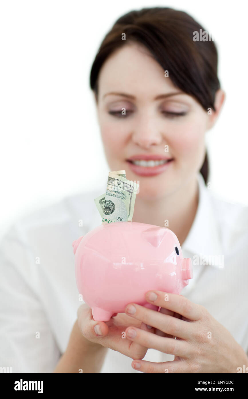 Young businesswoman saving money in a piggybank Stock Photo - Alamy