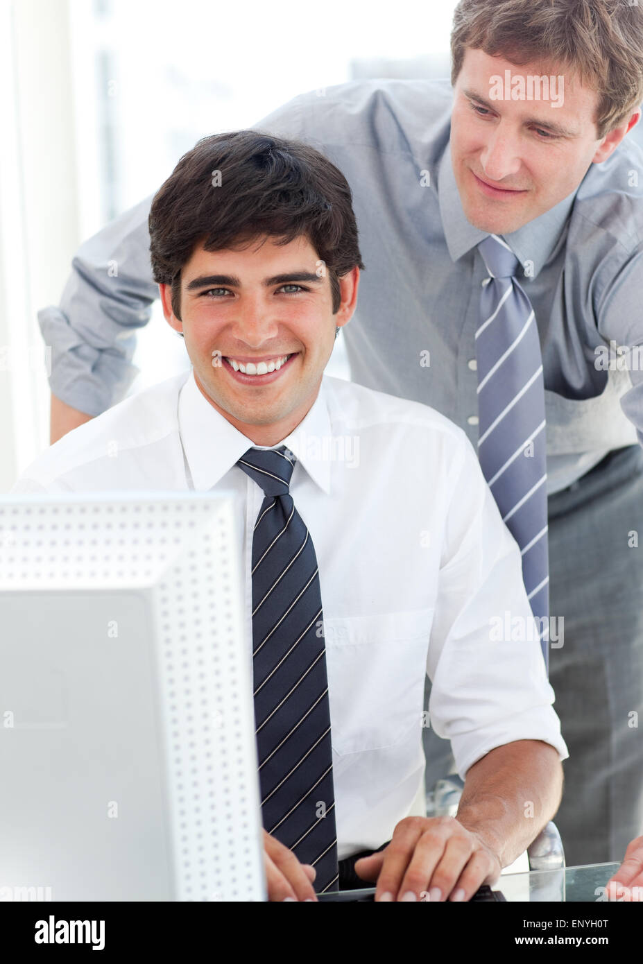 Handsome businessman working at a computer with his manager Stock Photo ...