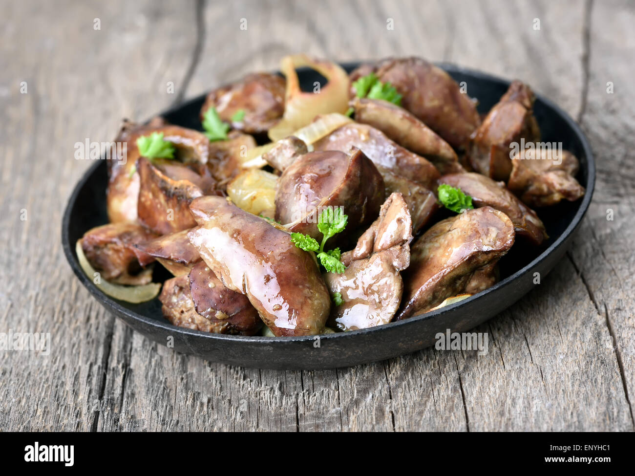 Cooked chicken liver in frying pan on wooden table Stock Photo Alamy
