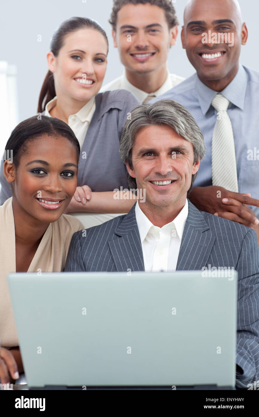 A diverse business team working at a laptop Stock Photo - Alamy