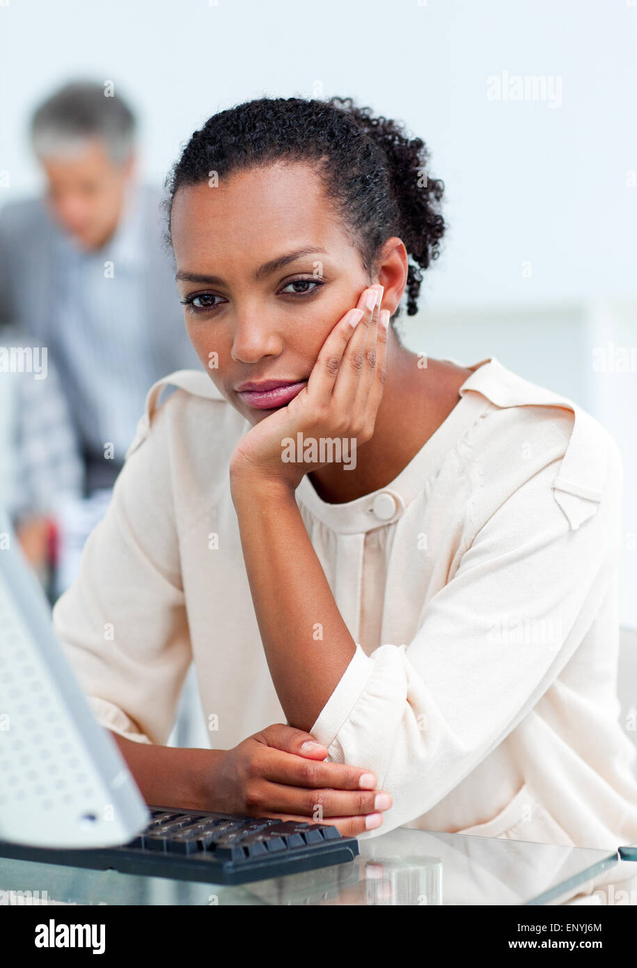 Bored businesswoman at her desk Stock Photo