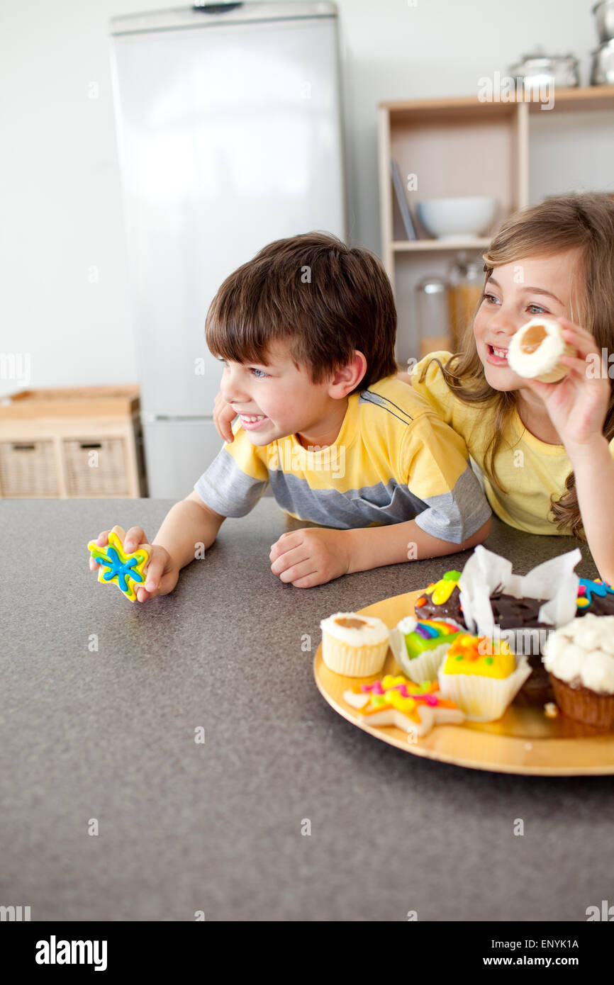 Child Getting Two Cookies Smiling children showing their cookies Stock Photo - Alamy