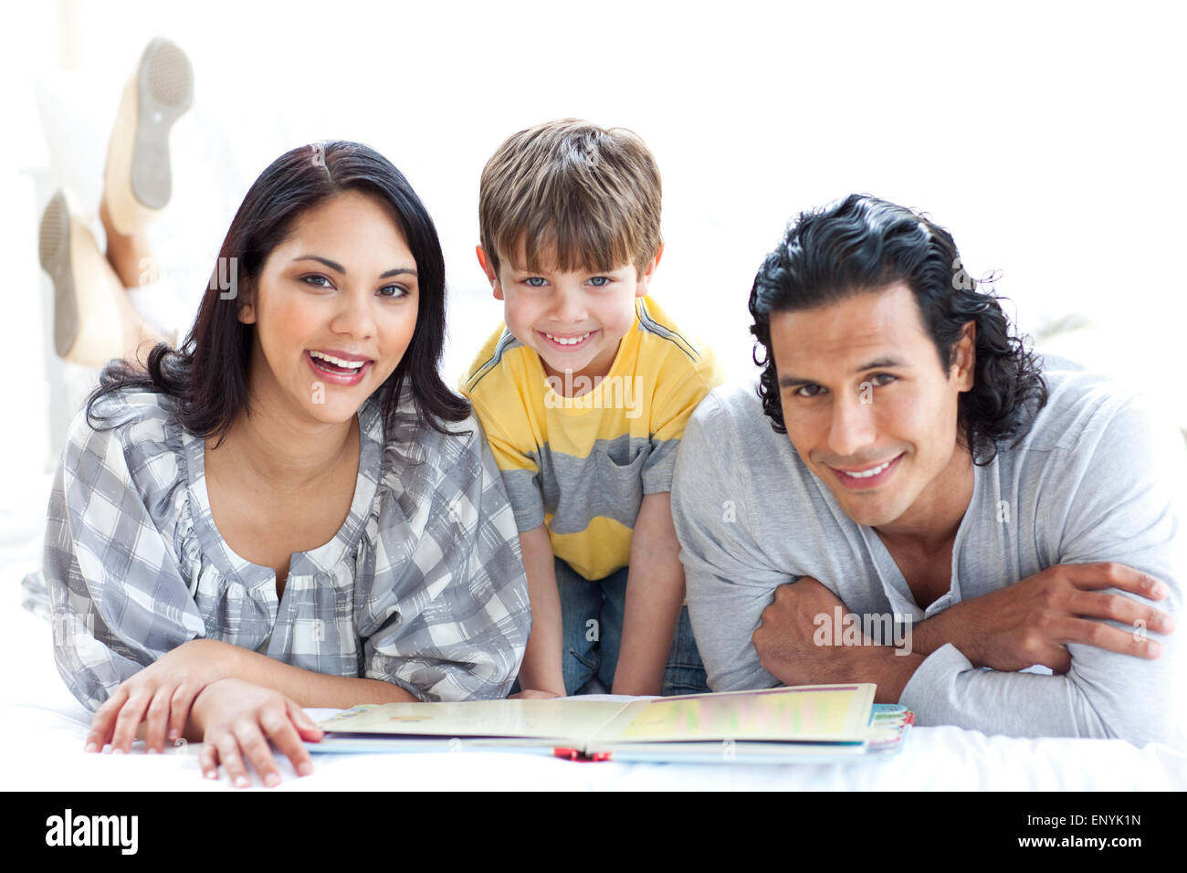 Happy family reading book together Stock Photo - Alamy