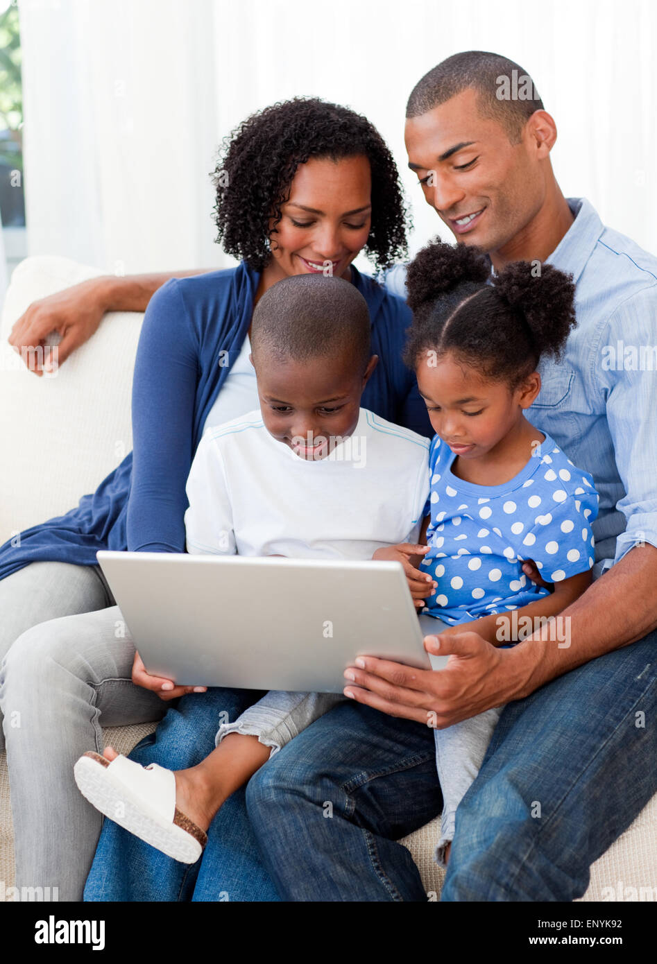 Happy family using a laptop Stock Photo - Alamy