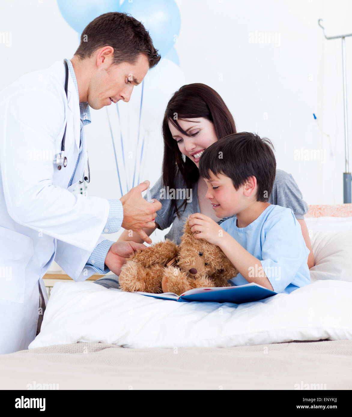 Attractive doctor playing with a little boy and his mother Stock Photo ...