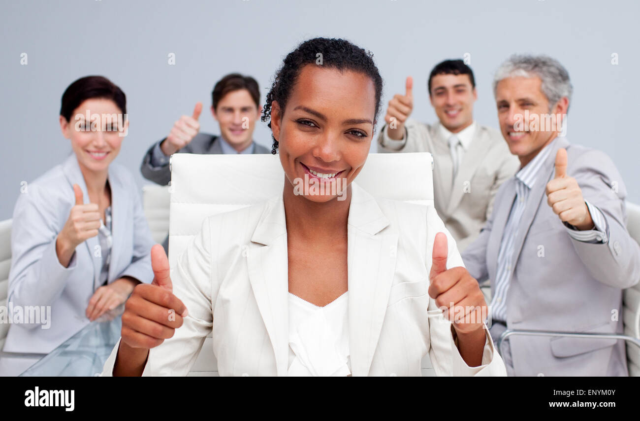 Happy business team celebrating a sucess with thumbs up Stock Photo - Alamy