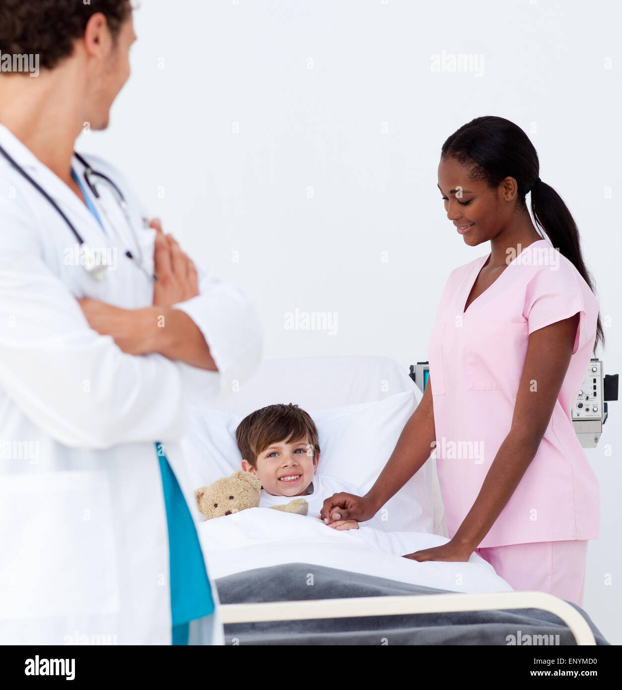 Pediatrician and nurse attending to a little boy Stock Photo - Alamy