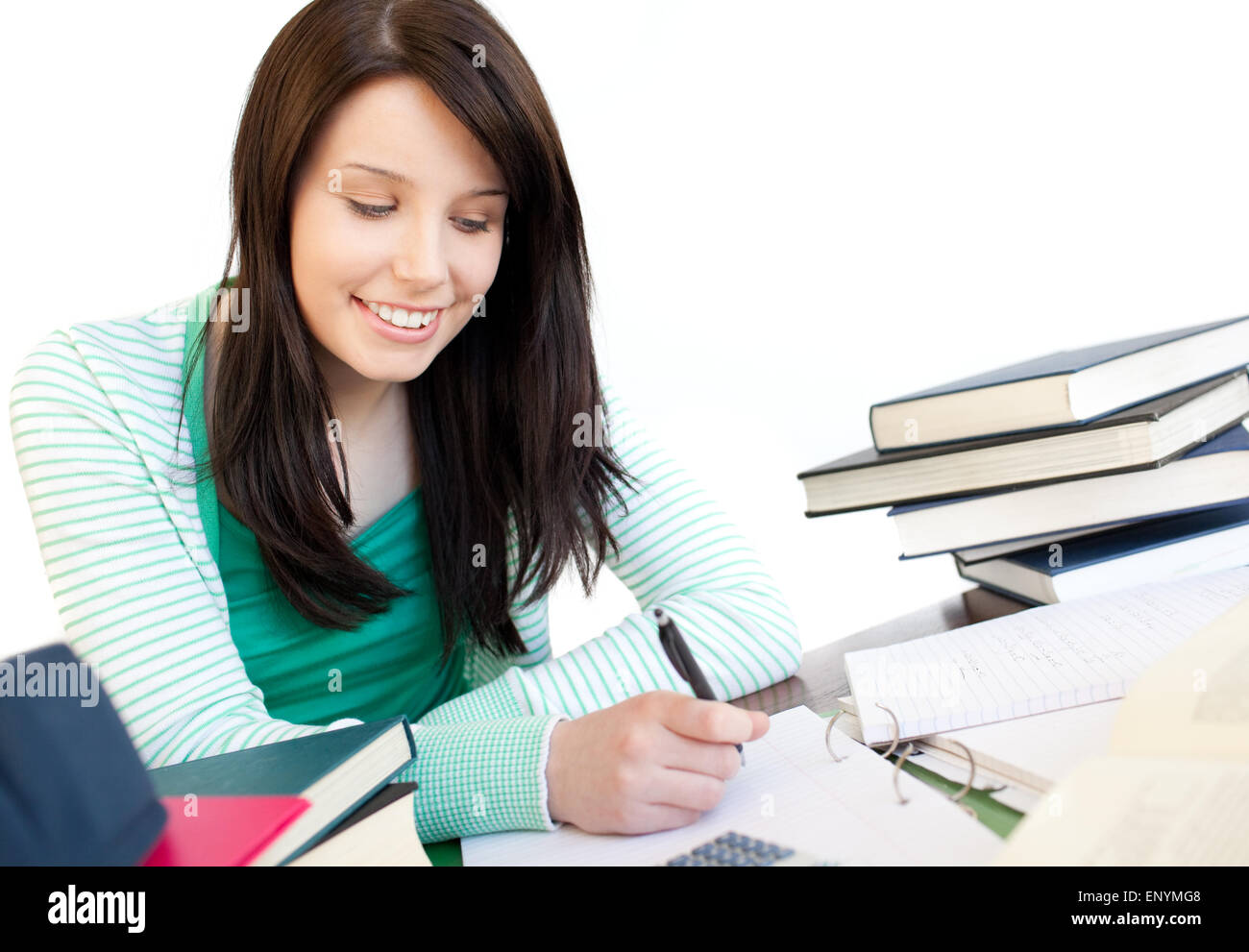Smiling teen girl studying on a desk Stock Photo - Alamy