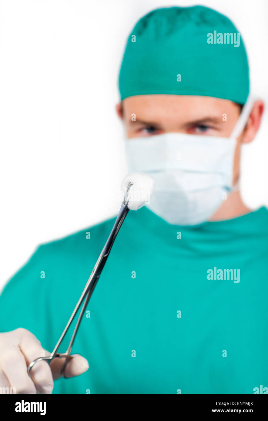 Charismatic male surgeon holding surgical forceps Stock Photo Alamy