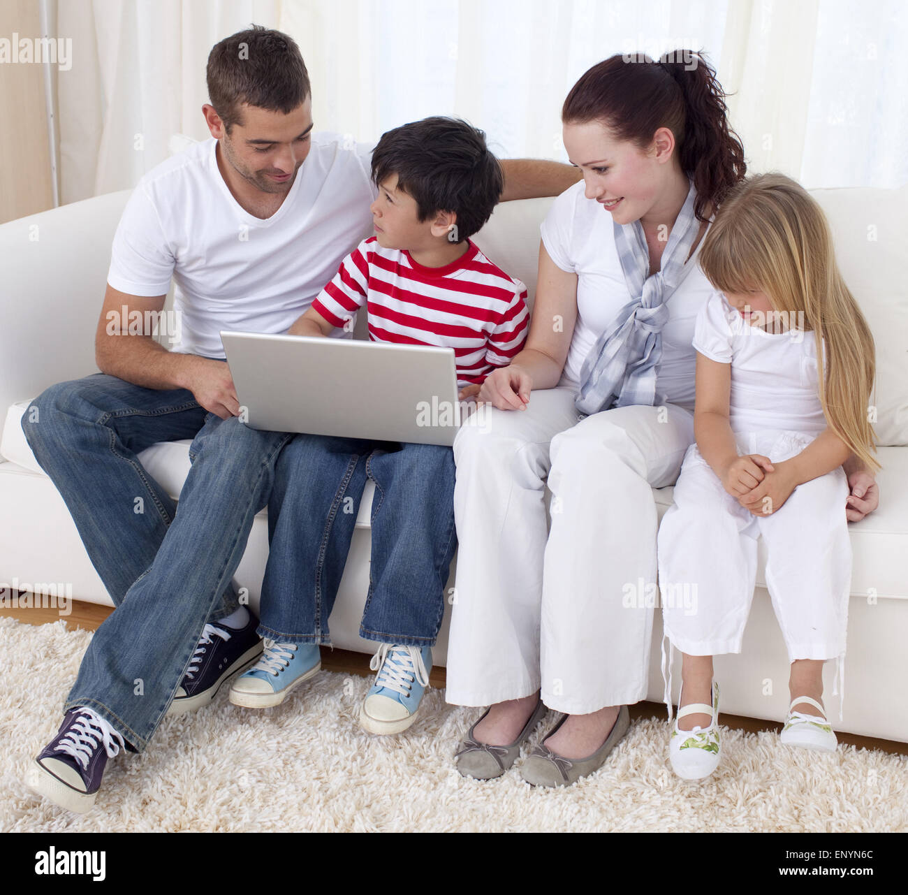 Family at home using a laptop Stock Photo - Alamy