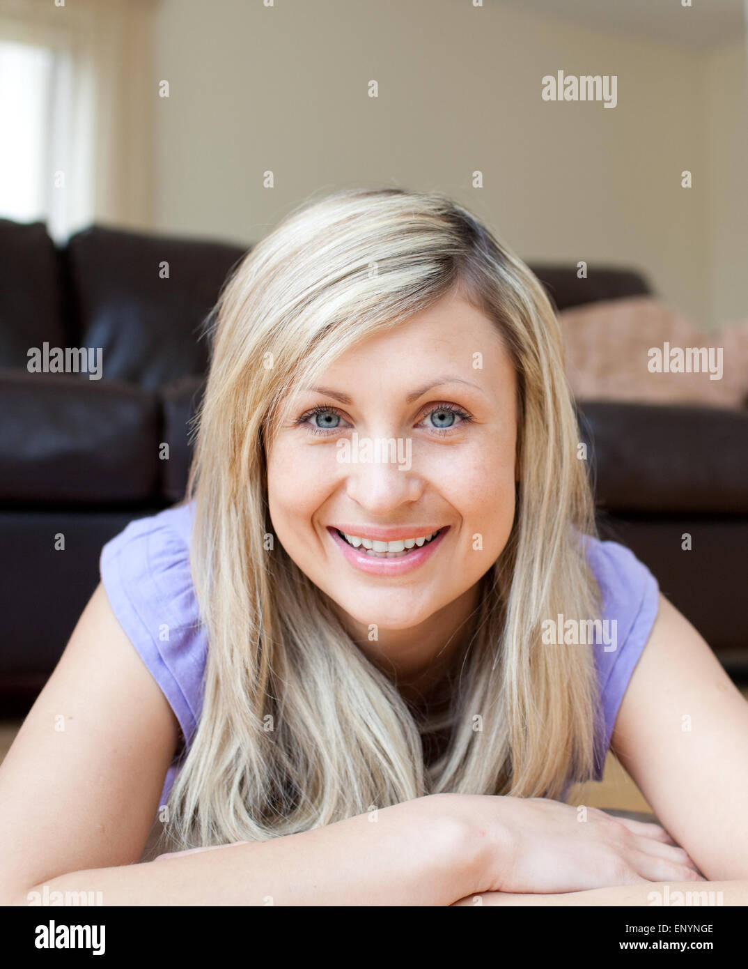 Laughing young woman lying on the floor Stock Photo Alamy