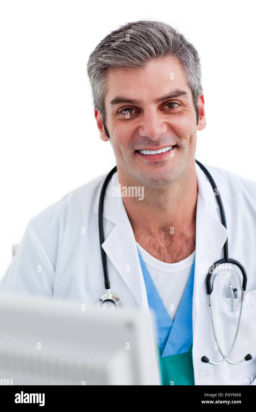 Portrait of a male doctor holding a stethoscope against a white ...