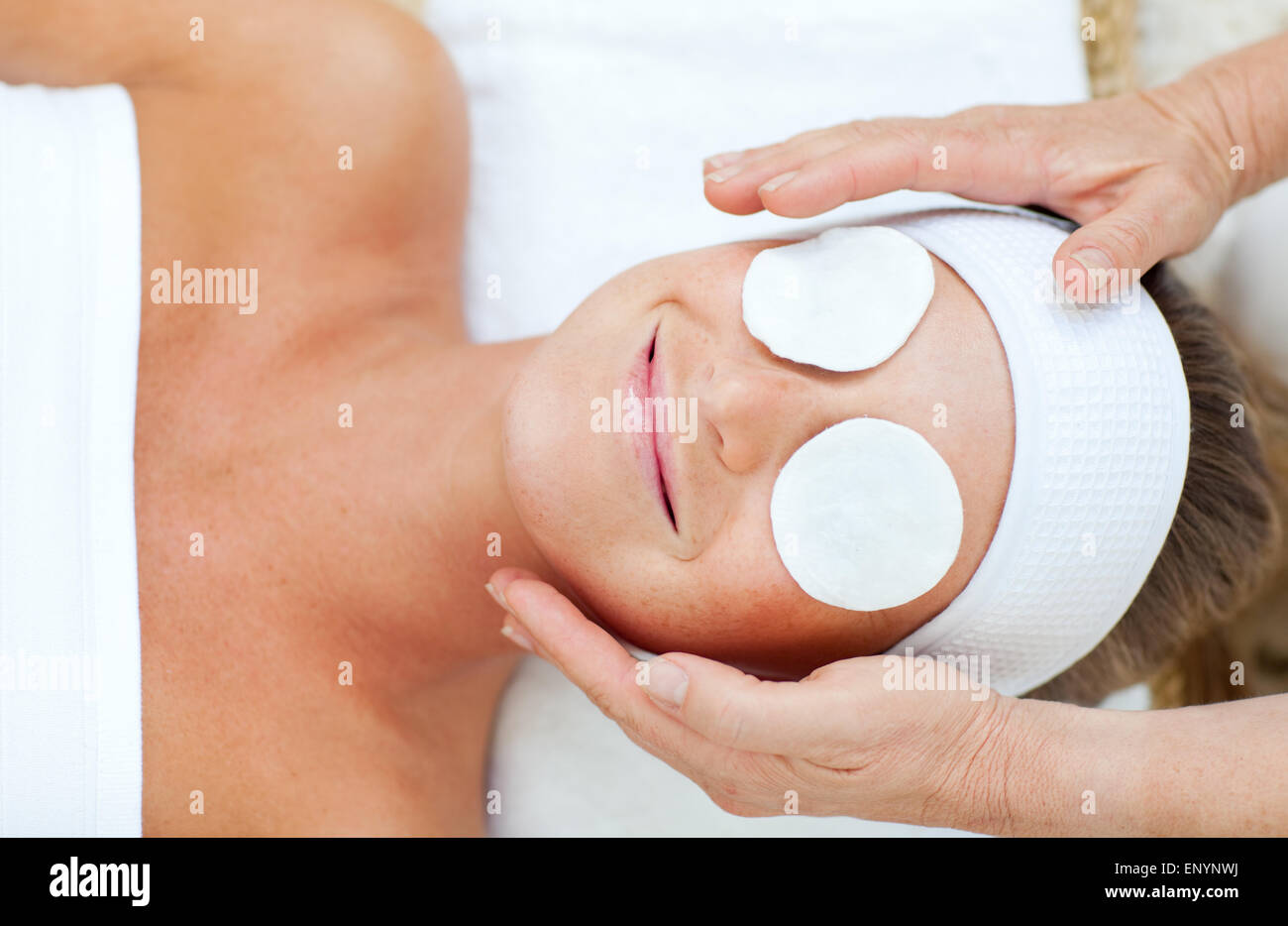 Smiling woman enjoying a head massage Stock Photo