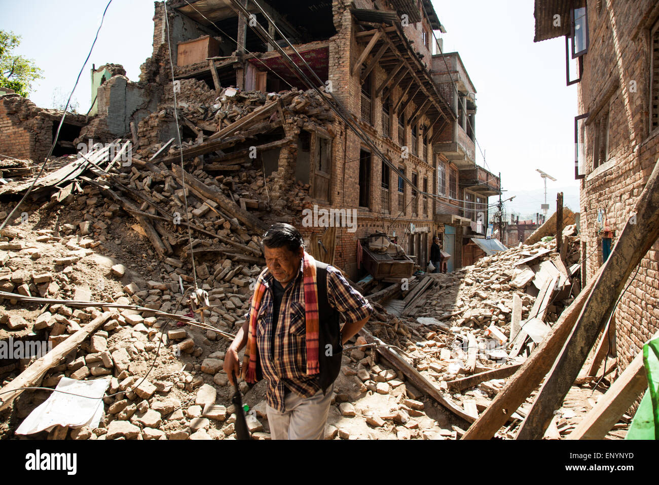 A man walks through the rubble of houses damaged by the earthquake in Sankhu Village near Kathmandu, Nepal. Stock Photo