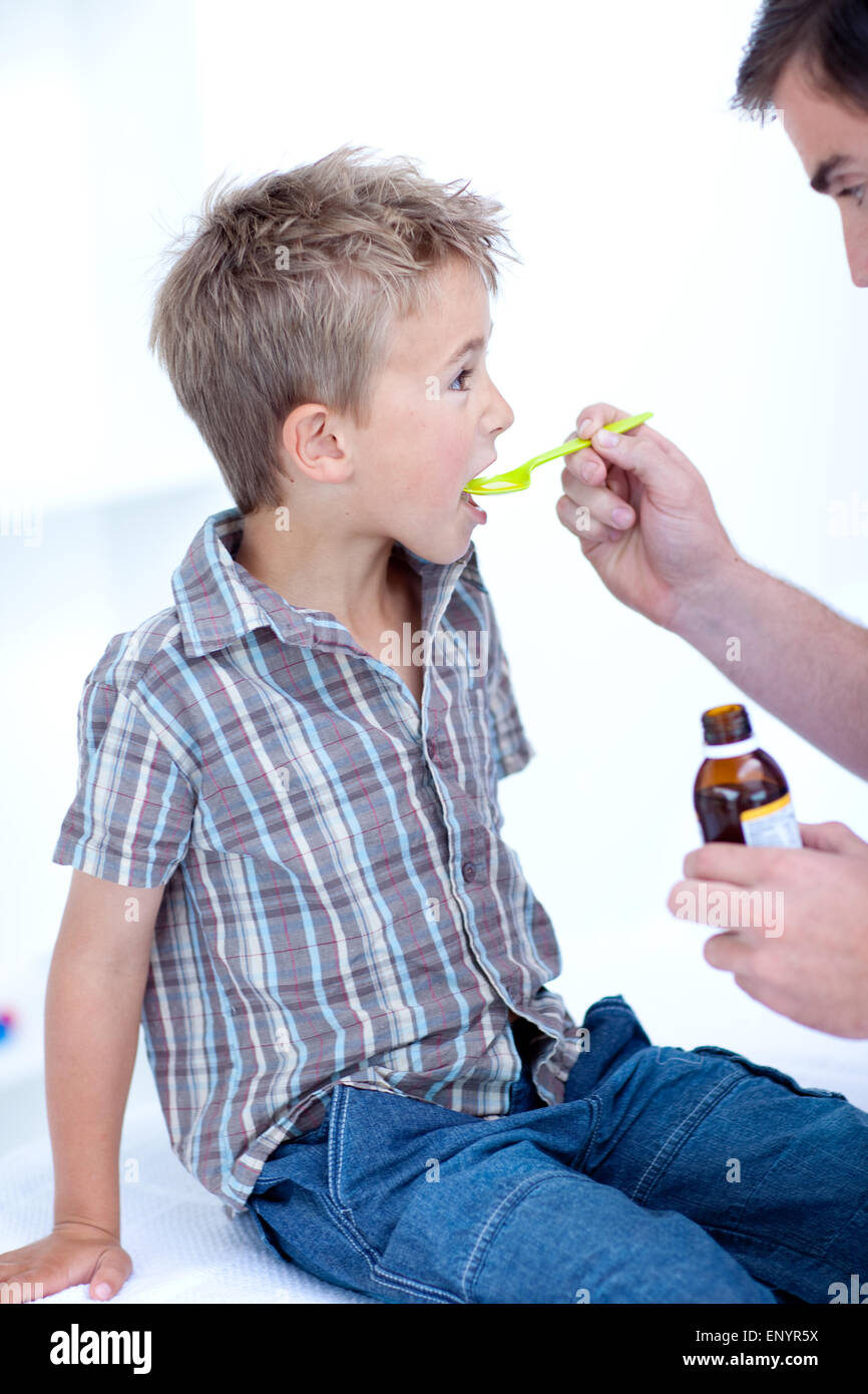 Child taking cough medicine Stock Photo Alamy