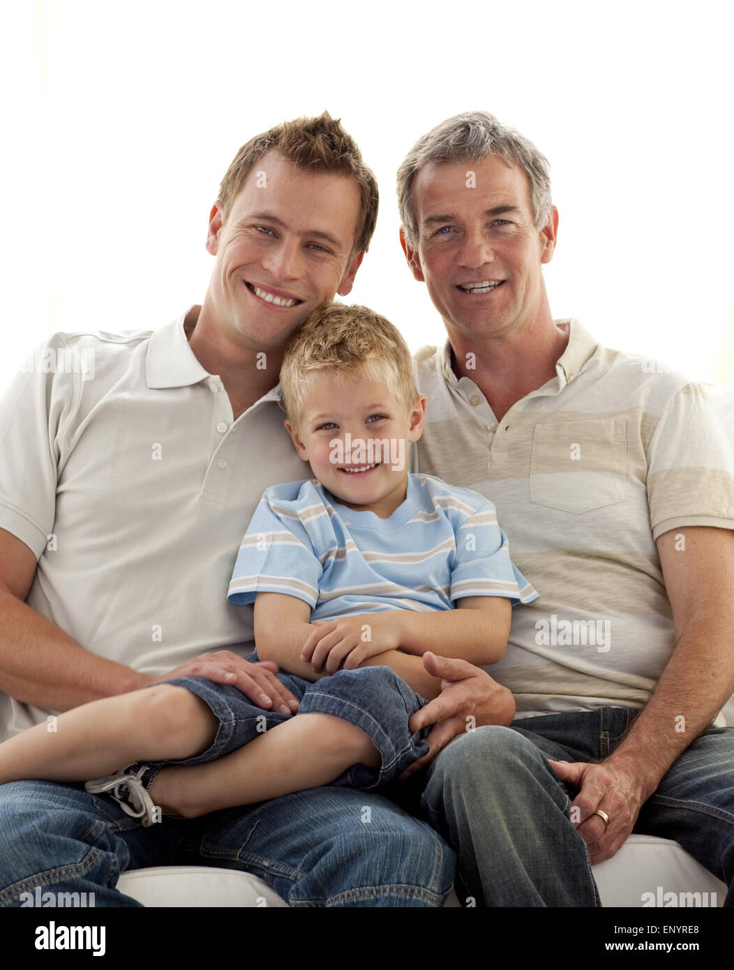 Smiling son, father and grandfather sitting on sofa Stock Photo - Alamy