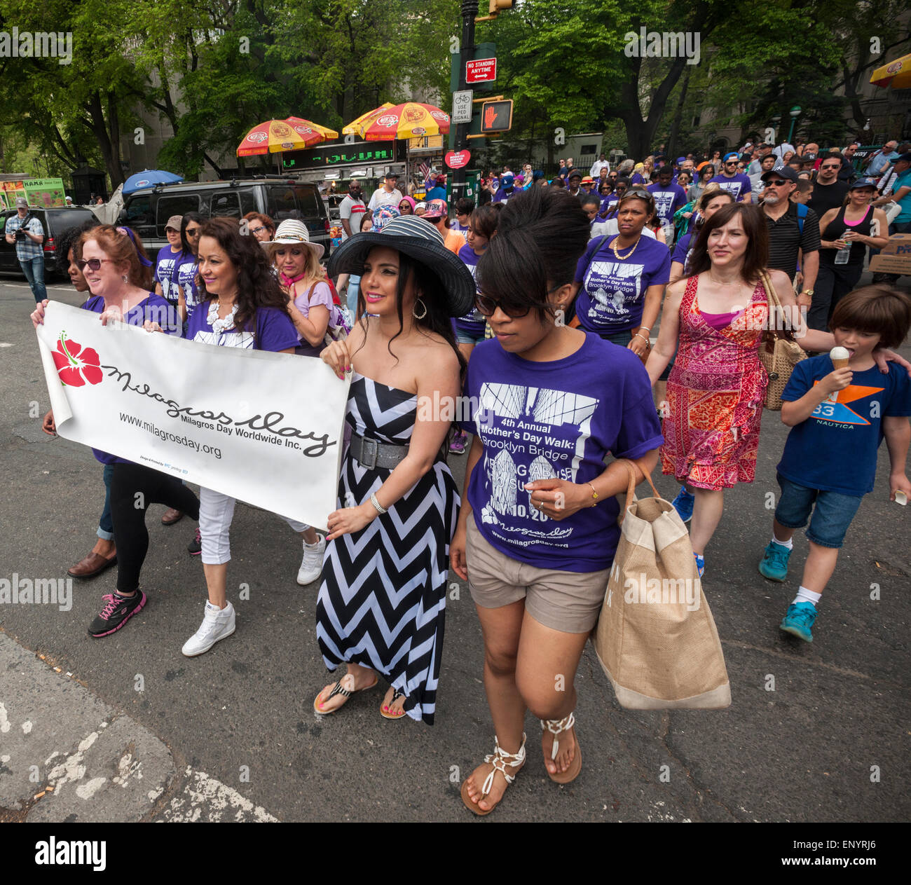Members and supporters of the group Milagros Day Worldwide participate in their Mother's Day Walk against domestic violence starting at City Hall in New York on Mother's Day, Sunday, May 10, 2015. Several hundred men, women and children, some of them victims,  participated in their warm up pep rally and walked across the bridge to raise money and awareness for the victims of domestic violence. (© Richard B. Levine) Stock Photo