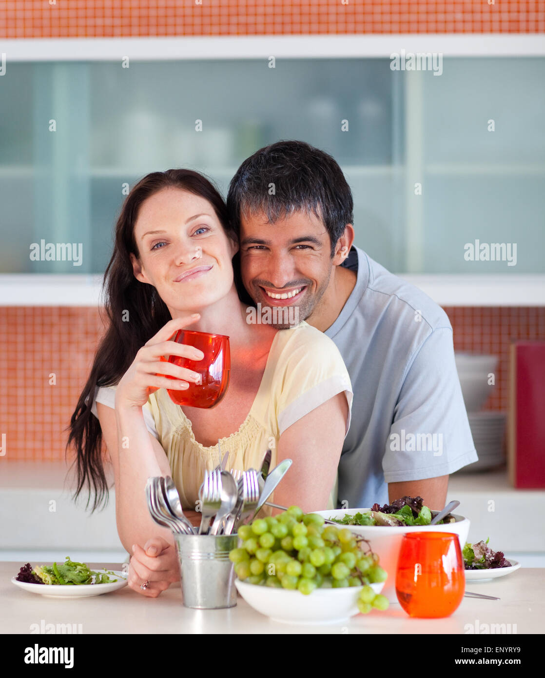Couple eating and drinking in the kitchen Stock Photo Alamy
